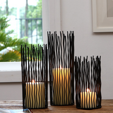 Load image into Gallery viewer, Estel Black Wire Candle Holders by Allthingscurated have openwork pattern that resembles willow-like branches in a cylindrical arrangement.  Crafted from iron and in black finish, these candle holders come in 3 sizes.
