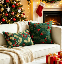 Load image into Gallery viewer, Two green throw pillows embroidered with red berries and gold leaves sit on a white sofa, perfect home decor in front of a Christmas tree and a fireplace.
