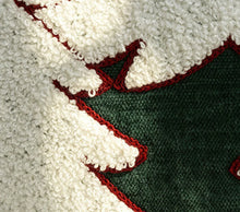 Load image into Gallery viewer, Dark green fabric embroidered with white Christmas tree detail.
