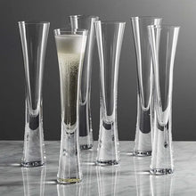 Load image into Gallery viewer, Combining style and functionality, Fion Champagne Flutes by Allthingscurated are hand-crafted from 100% lead-free crystal glass. These elegant flutes boast a sleek, modern, minimalistic design with a weighty base to provide stability and helps to maintain the temperature of your champagne. Comes in a set of 2 or 4 glasses. They are perfect for special occasion and make a stunning wedding gift.
