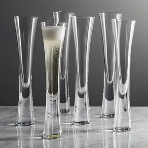 Combining style and functionality, Fion Champagne Flutes by Allthingscurated are hand-crafted from 100% lead-free crystal glass. These elegant flutes boast a sleek, modern, minimalistic design with a weighty base to provide stability and helps to maintain the temperature of your champagne. Comes in a set of 2 or 4 glasses. They are perfect for special occasion and make a stunning wedding gift.