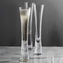 Load image into Gallery viewer, Combining style and functionality, Fion Champagne Flutes by Allthingscurated are hand-crafted from 100% lead-free crystal glass. These elegant flutes boast a sleek, modern, minimalistic design with a weighty base to provide stability and helps to maintain the temperature of your champagne. Comes in a set of 2 or 4 glasses. They are perfect for special occasion and make a stunning wedding gift.
