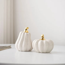 Load image into Gallery viewer, Glazed Ceramic Pumpkins by Allthingscurated spot a sculptural design that are perfect for adding a chic and stylish touch to your Halloween and Thanksgiving celebrations. Available in two designs in orange or white, let these ornamental pumpkins transform your home into a cozy autumn oasis.
