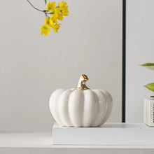 Load image into Gallery viewer, Glazed Ceramic Pumpkins by Allthingscurated spot a sculptural design that are perfect for adding a chic and stylish touch to your Halloween and Thanksgiving celebrations. Available in two designs in orange or white, let these ornamental pumpkins transform your home into a cozy autumn oasis.
