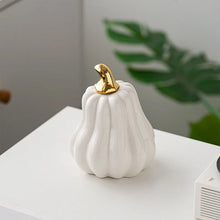 Load image into Gallery viewer, Glazed Ceramic Pumpkins by Allthingscurated spot a sculptural design that are perfect for adding a chic and stylish touch to your Halloween and Thanksgiving celebrations. Available in two designs in orange or white, let these ornamental pumpkins transform your home into a cozy autumn oasis.
