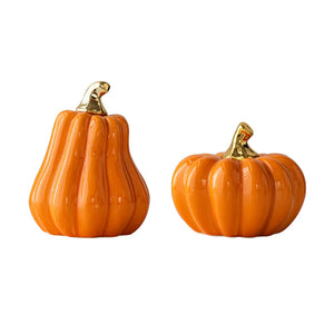 Glazed Ceramic Pumpkins by Allthingscurated spot a sculptural design that are perfect for adding a chic and stylish touch to your Halloween and Thanksgiving celebrations. Available in two designs in orange or white, let these ornamental pumpkins transform your home into a cozy autumn oasis. Featured here is the Orange Set consisting of a tall and short pumpkin.