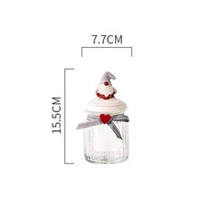 Load image into Gallery viewer, Christmas Festive Storage Jars by Allthingscurated are the perfect jars to keep all your festive treats fresh and delicious. The jars are airtight and each jar is topped with a ceramic lid decorated with a Santa Claus, Christmas Tree, Penguin, Gnome or Fox. Comes in 2 sizes with capacity of 300ml or 10 ounce and 1000ml or 34 ounce. Featured here is a small  Gnome jar.
