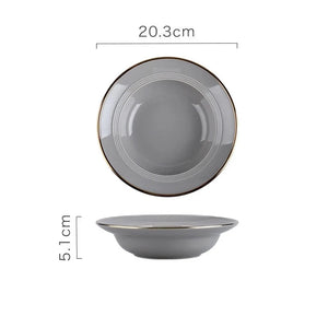 Kovan Ceramic Pasta/Soup Bowl by Allthingscurated is a stylish and functional bowl that offers versatility and practicality in usage. Perfectly sized for pasta, soups, stews, desserts and more. It’s a must-have addition to your dinnerware collection for all occasions from formal dining to everyday casual meals. Featured here is our Kovan  Pasta Bowl in gray with gold rim.