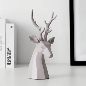 This beautiful Deer Head Bust sculpture is made of resin and comes available in 4 colors of black, white, gray and teal.  Measuring 26cm or 10 inches in height and 11.5cm or 4.5 inches in width. This figurine spots a contemporary design with sculptural form inspired by Origami. This decorative piece will add timeless elegance to your space year-round. Perfect for festive tablescapes, mantels and shelves.  This is a deer head bust in Gray.