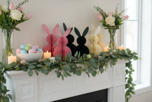 Load image into Gallery viewer, Six paper bunny decorations in pink, dark green, and beige on a white mantel. This curated set of two Honeycomb Easter Bunnies by Allthingscurated instantly transforms any space into a festive Easter wonderland. Their adorable silhouettes add personality and warmth to your holiday décor. Quick assembly and compact storage, with proper care, they remain beautiful year after year. Comes in 5 delightful colors.
