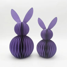 Load image into Gallery viewer, This curated set of two Honeycomb Easter Bunnies by Allthingscurated instantly transforms any space into a festive Easter wonderland. Their adorable silhouettes add personality and warmth to your holiday décor. Quick assembly and compact storage, with proper care, they remain beautiful year after year. Comes in 5 delightful colors. Shown here is a set of two purple paper bunny decorations on a white background.
