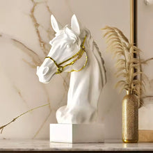 Load image into Gallery viewer, White horse head sculpture with gold bridle on a marble surface. Fargo Horse Head Bust by Allthingscurated is an elegant decorative sculpture with meticulous detail and flaunts a gorgeous gold-accented bridle. Perfect for horse enthusiasts and makes a meaningful gift for those born under the Horse zodiac sign. And expertly crafted to complement both timeless classic and contemporary modern interiors.
