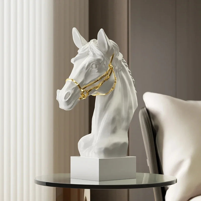 White horse head sculpture with gold bridle on a round table. Fargo Horse Head Bust by Allthingscurated is an elegant decorative sculpture with meticulous detail and flaunts a gorgeous gold-accented bridle. Perfect for horse enthusiasts and makes a meaningful gift for those born under the Horse zodiac sign. And expertly crafted to complement both timeless classic and contemporary modern interiors.