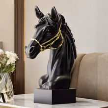 Load image into Gallery viewer, Black horse head sculpture with gold bridle on a table. Fargo Horse Head Bust by Allthingscurated is an elegant decorative sculpture with meticulous detail and flaunts a gorgeous gold-accented bridle. Perfect for horse enthusiasts and makes a meaningful gift for those born under the Horse zodiac sign. And expertly crafted to complement both timeless classic and contemporary modern interiors.
