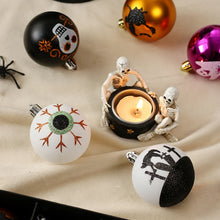 Load image into Gallery viewer, Halloween Decorative Bauble Set by Allthingscurated comes in a box containing 16 hand-painted ball ornaments featuring unique designs such as skulls, black cats, witches on broomsticks, white ghosts and creepy eyeballs. These decorated ornaments are perfect for adding an eclectic and quirky touch to your tree or home.
