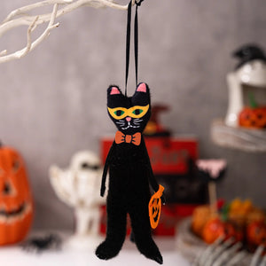Black cat Halloween ornament with a bow tie on a decorative background. These adorable Halloween Decorative Hangings Dolls by Allthingscurated spark joy and give your Holiday decor a fun and eerie vibe.