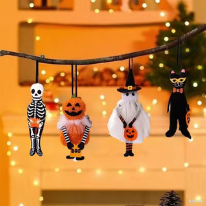 Halloween-themed ornaments including a skeleton, pumpkin, ghost, and black cat on a branch with a blurred festive background. These adorable Halloween Decorative Hangings Dolls by Allthingscurated spark joy and give your Holiday decor a fun and eerie vibe.