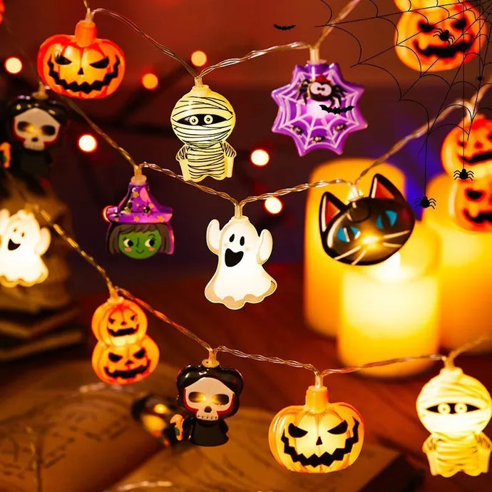 Halloween LED Party Lights by Allthingscurated featuring playful mummies, pumpkins, ghosts, skeletons and spiders add a fun and festive touch to your Halloween décor. The warm glow of the LEDs enhances the eerie ambiance, making your space perfect for Halloween celebrations and parties. Comes in 2 lengths and battery-powered.