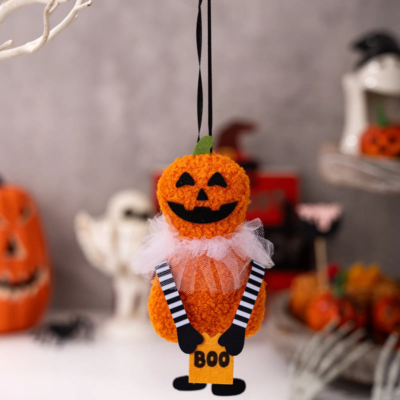 Halloween-themed ornament with a pumpkin face and 'BOO' text, hanging against a festive background. These adorable Halloween Decorative Hangings Dolls by Allthingscurated spark joy and give your Holiday decor a fun and eerie vibe.