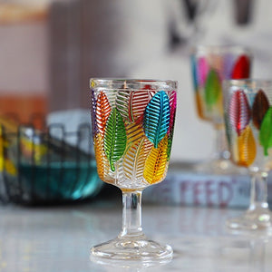 Havana Embossed Leaves Vintage Goblets by Allthingscurated, featuring contrasting multi-colored leaves embossed onto lead-free glass vessel. Charming with a touch of vintage vibe.  Shown here is the glass with a clear stem and base.