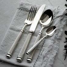 Load image into Gallery viewer, Julius Silver Stainless Steel Flatware Sets by Allthingscurated are crafted from high-quality 18/10 stainless steel. The weighty and solid construction provides a luxurious feel, while the Roman column handle design adds a touch of elegance. The mirror polished surface reflects a bright and shiny finish, adding a touch of sophistication to any table.
