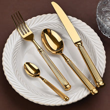 Load image into Gallery viewer, Julius Gold Stainless Steel Flatware Sets by Allthingscurated are crafted from high-quality 18/10 stainless steel. The weighty and solid construction provides a luxurious feel, while the Roman column handle design adds a touch of elegance. The mirror polished surface reflects a bright and shiny finish, adding a touch of sophistication to any table.
