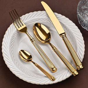 Julius Gold Stainless Steel Flatware Sets by Allthingscurated are crafted from high-quality 18/10 stainless steel. The weighty and solid construction provides a luxurious feel, while the Roman column handle design adds a touch of elegance. The mirror polished surface reflects a bright and shiny finish, adding a touch of sophistication to any table.