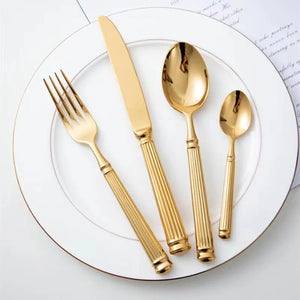 Julius Gold Stainless Steel Flatware Sets by Allthingscurated are crafted from high-quality 18/10 stainless steel. The weighty and solid construction provides a luxurious feel, while the Roman column handle design adds a touch of elegance. The mirror polished surface reflects a bright and shiny finish, adding a touch of sophistication to any table.