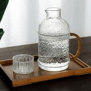 Kiv Hammered Glass Pitcher with Cover in 2 liter or 68 ounce capacity by Allthingscurated. Comes with a hemp rope handle for a rustic vibe.  Large capacity and heat-resistant. It's the perfect thirst quencher for summer.