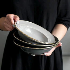 Kovan Ceramic Pasta/Soup Bowl by Allthingscurated is a stylish and functional bowl that offers versatility and practicality in usage. Perfectly sized for pasta, soups, stews, desserts and more. It’s a must-have addition to your dinnerware collection for all occasions from formal dining to everyday casual meals. Comes in gray and black.