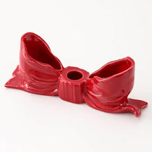 Load image into Gallery viewer, Red ceramic bow-shaped object on a white background. Fashion Bow Candle Holder by Allthingscurated spots a distinctive knot design, beautiful yet practical. Perfect for wedding celebrations, home styling, or to infuse warmth and romance into any living space. Available in three colors and 2 sizes. 
