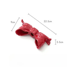 Load image into Gallery viewer, Large Red bow-shaped candle holder with measurements on a white background. Fashion Bow Candle Holder by Allthingscurated spots a distinctive knot design, beautiful yet practical. Perfect for wedding celebrations, home styling, or to infuse warmth and romance into any living space. Available in three colors and 2 sizes.
