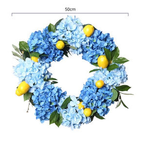 Summer Lemon Hydrangea wreath by Allthingscurated features a vibrant and cheerful yellow and blue color scheme, evoking images of sunny blue skies and warm summer days. The wreath adds a pop of color to your door and bring a little extra happiness to your home. Measures approximately 50cm or 19.7 inches in diameter.