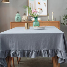 Load image into Gallery viewer, Introducing Ruffled Cotton Tablecloth by Allthingscurated. Made from 100% cotton, our tablecloth exudes French country charm with its romantic, frilly ruffles. With the perfect balance of decorative and laid-back, they have a welcoming and comforting vibe. Available in 8 solid colors. Featured here is the Light Gray tablecloth.
