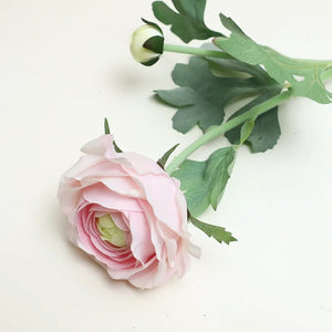 Silk Ranunculus by Allthingscurated are perfect for creating stunning table displays and wedding bouquets. Come in 4 beautiful colors, they add a touch of timelessness and beauty to every home.  Refresh your living space effortlessly with these gorgeous florals that come in a pack of 4 stalks. Seen here is blossom in Pink.