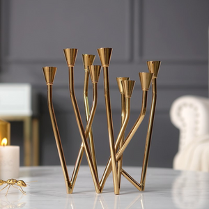 Lysa Gold Candelabra by Allthingscurated spots an asymmetrical design and clean lines that exude modern elegance. With 9 arms for taper candles, the gold-tone metal surface reflects the glow of the flames, creating a warm and captivating atmosphere. It’s stunning centerpiece for any occasion and decorative accent for any event or space.