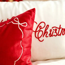 Load image into Gallery viewer, Two decorative pillows for Christmas shopping: one red pillow featuring a white embroidered outline of a bow, and one white pillow embroidered with the red word Christmas.
