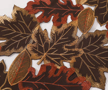 Load image into Gallery viewer, Close-up of embroidered leaves with brown, red, and gold colors on a white background. By Allthingscurated.
