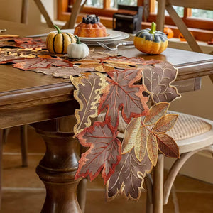 Autumn Maple Leaf Placemat and Table Runner by Allthingscurated featured detailed embroidery design of maple leaves in a beautiful spectrum of colors from light brown, to orangey and reddish hues. Perfect for creating a stunning autumnal table setting and adding a refined autumn touch to your living space and autumn-themed home décor.