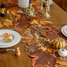 Load image into Gallery viewer, Autumn Maple Leaf Placemat and Table Runner by Allthingscurated featured detailed embroidery design of maple leaves in a beautiful spectrum of colors from light brown, to orangey and reddish hues. Perfect for creating a stunning autumnal table setting and adding a refined autumn touch to your living space and autumn-themed home décor.
