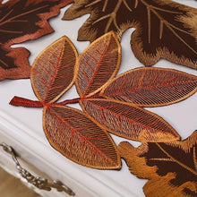 Load image into Gallery viewer, Autumn Maple Leaf Placemat and Table Runner by Allthingscurated featured detailed embroidery design of maple leaves in a beautiful spectrum of colors from light brown, to orangey and reddish hues. Perfect for creating a stunning autumnal table setting and adding a refined autumn touch to your living space and autumn-themed home décor.
