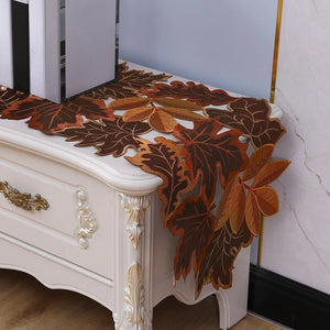 Autumn Maple Leaf Placemat and Table Runner by Allthingscurated featured detailed embroidery design of maple leaves in a beautiful spectrum of colors from light brown, to orangey and reddish hues. Perfect for creating a stunning autumnal table setting and adding a refined autumn touch to your living space and autumn-themed home décor.