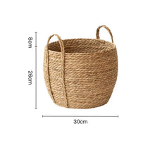 Load image into Gallery viewer, Leedon Woven Baskets by Allthingscurated are hand-woven from seagrass which is an eco-friendly material. The baskets feature sturdy handles for easy transportation and lend a rustic charm to any space. Perfect for storing household items or displaying your favorite plants. Available in 3 sizes. Featured here is the medium basket measuring 26cm or 10 inches in height and 30cm or 11.7 inches in width.
