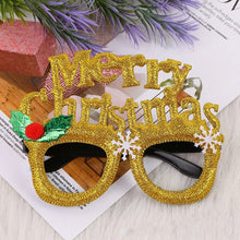 Load image into Gallery viewer, These Christmas Party Glasses by Allthingscurated are the perfect fun accessory for festive parties and gatherings during the holiday season. Their unique design and cheerful holiday style make them great props for creating memorable moments an happy Instagram posts to capture the joy of the season. Featured here is Merry Gold design.
