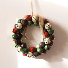 Load image into Gallery viewer, Christmas Jingle Bells Wreath by Allthingscurated comes in 3 semi-matte colors of Red, Multi Colors and Gold. The Multi Color Wreath features clusters of bell in green, red, ivory and brown. Each wreath is formed of bells made of iron entwined onto a jute rope and truly jingle with each movement. Measures approximately 18cm or 7 inches in width and height.  This is a Multi Color Wreath.
