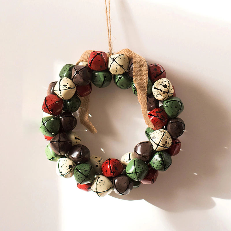 Christmas Jingle Bells Wreath by Allthingscurated comes in 3 semi-matte colors of Red, Multi Colors and Gold. The Multi Color Wreath features clusters of bell in green, red, ivory and brown. Each wreath is formed of bells made of iron entwined onto a jute rope and truly jingle with each movement. Measures approximately 18cm or 7 inches in width and height.  This is a Multi Color Wreath.
