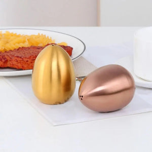 Introducing Metallic Egg Shape Salt and Pepper Shaker by Allthingscurated. This shaker is crafted from stainless steel and comes in 5 delightful colors. Perfect for Easter celebrations and as a housewarming gift. It will add a touch of playfulness to your dining table and spice up your meals with a little humor.