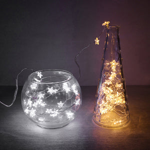 Mini Stars LED Fairy Lights by Althingscurated. Create a cozy and festive atmosphere with these decorative lights that offer a warm, tinkling glow. These mini stars are attached to silver wire that is bendable and easy to manipulate so you can fit them into tiny spaces or wrap around objects to enhance your favorite decorations.  Comes in 6 different lengths from 1 meters to 6 meters or 39 to 236 inches. Available in warm white or white lights.