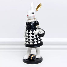 Load image into Gallery viewer, Our Regal Rabbit Family Figurines by Allthingscurated are beautifully-crafted and decorative. Made high-quality resin, these unique figurines will add a touch of elegance and whimsy to your home décor. Available in 6 designs, they are the perfect additions to your spring and Easter decorations. Featured here is Missy Rabbit.
