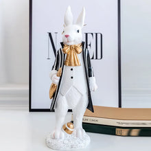 Load image into Gallery viewer, Our Regal Rabbit Family Figurines by Allthingscurated are beautifully-crafted and decorative. Made high-quality resin, these unique figurines will add a touch of elegance and whimsy to your home décor. Available in 6 designs, they are the perfect additions to your spring and Easter decorations. Featured here is Mr Rabbit.
